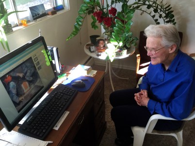 Doctor Huston at home in Edmonton watching a video on her computer showing workers in Nepal rescuing three men from a collapsed building. Photo shot on Sunday, 26 April 2015.