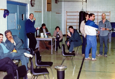 Click to enlarge. The scene that morning in the gym at the Max. Who's who, starting from left to right: Prisoner Jerry Crews [only partly in picture], killer of Edmonton Police Officer Ezio Farone; Prisoner Blair Pelletier, Saskatchewan killer; Deputy-Warden Al Swaine, leaning against the wall; an unidentified person making notes; Judy Fantham, manager of CBC Radio in Edmonton; prisoner Steve Ford [forget what he was in for, but it wasn't shoplifting]; Brad [Edmonton AM researcher], Gord McAlpine [CBC Sports announcer] and prisoner Dean Cooper [Calgary killer], holding a real coffee mug.