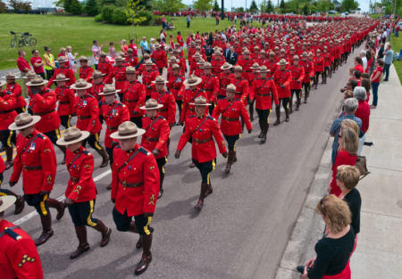 Mounties on their way to the Butterdome, in the University area, where the funeral service was held.