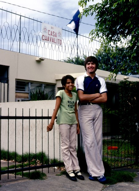 Sound technician Larry Arnault with a child outside Tacon's headquarters in Managua. 