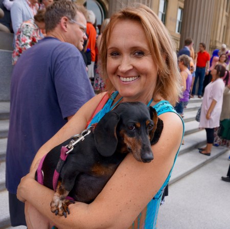 One tired puppy with his/her best friend.