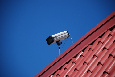 The sidewalk-facing surveillance camera, as I shot it on 23 June 2011. I don't know if this was the same camera that was on the roof in July 2005.